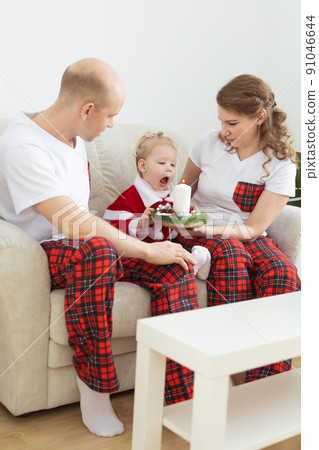 Child girl dressed in christmas dress with cochlear implants having fun at home - diversity and hearing aid and innovating technologies for treatment of deafness. 91046644