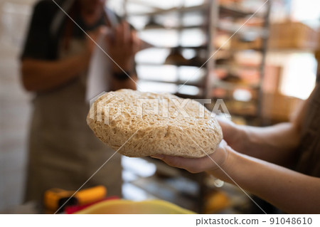 Wholemeal bread dough after fermentation and fermentation. The process of making bread. Front view. Wholemeal bread dough after fermentation and fermentation. The process of making bread. Front view. 91048610