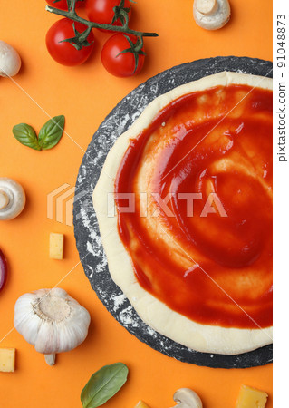 Concept of cooking pizza on orange background 91048873