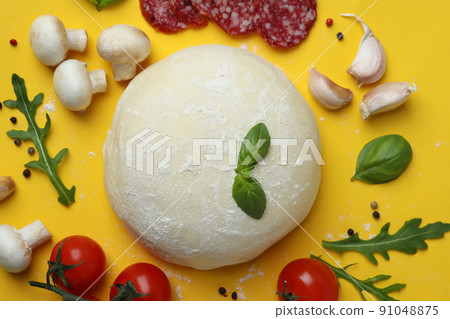 Concept of cooking pizza on yellow background 91048875