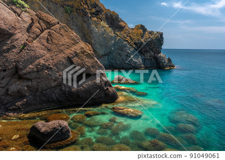 sea kayaking near the mountain coast 91049061