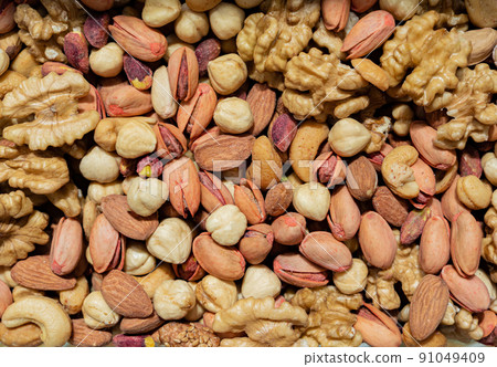 A mixture of peeled nuts for food as a background texture 91049409