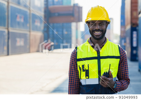 black worker African working engineer foreman radio control in port cargo shipping customs container yard 91049993