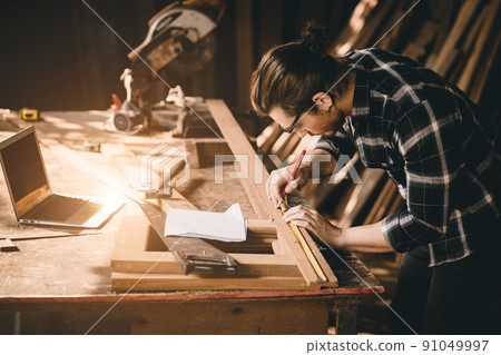 Carpenter man Wood worker working hand made furniture in shop factory industry. male wooden craftsman builder working in workshop with computer aided design. Carpenter man Wood worker working hand made furniture in shop factory industry. male wooden craftsman builder working in workshop with computer aided design. 91049997