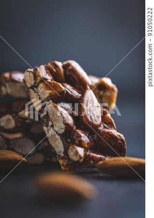 Sweet mini almond bars on black table. 91050222