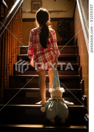 Little girl child sad looking at the alone at the stairs Little girl child sad looking at the alone at the stairs 91050397