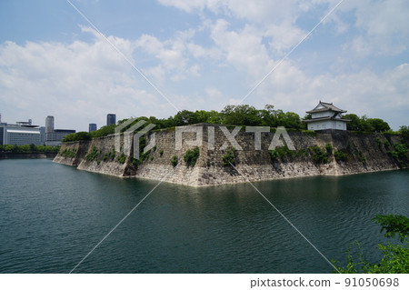 Osaka Castle in early summer, a magnificent stone wall and moat 91050698