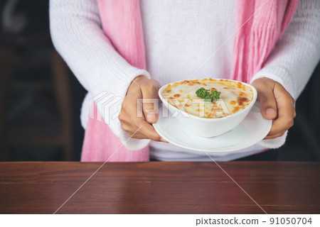 hand woman suggesting exquisite restaurant appetizer Spinach with cheese in white bowl 91050704