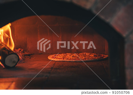 Italian pizza is cooked in a wood fired oven in stove Italian pizza is cooked in a wood fired oven in stove 91050706