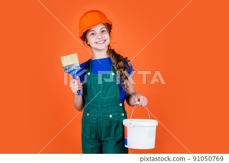 Working in repair shop. kid wear helmet on construction Working in repair shop. kid wear helmet on construction 91050769