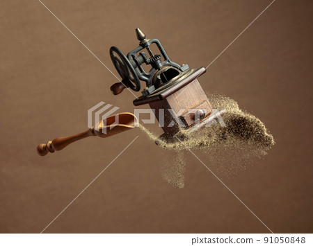 Old pepper grinder and a wooden spoon with pepper ground. Old pepper grinder and a wooden spoon with pepper ground. 91050848
