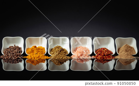 Small white bowls with various spices. Small white bowls with various spices. 91050850