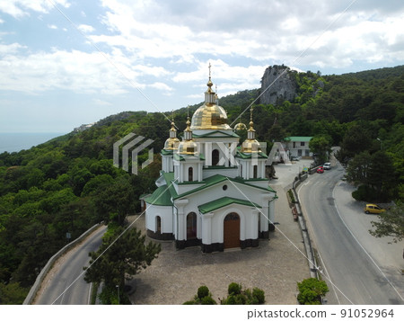 Christian church in the mountains above the sea. Temple of the Holy Archangel Michael in Oreanda. The southern coast of Crimea. Aerial view Christian church in the mountains above the sea. Temple of the Holy Archangel Michael in Oreanda. The southern coast of Crimea. Aerial view 91052964