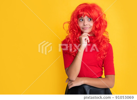 dreamy teen child with red long hair on yellow background dreamy teen child with red long hair on yellow background 91053069