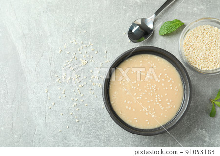 Concept of tasty food with tahini sauce on textured background 91053183