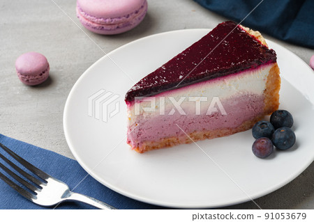 Piece of blueberry cheesecake on a white plate 91053679