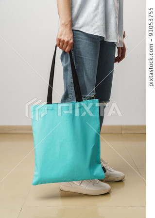 Cropped image of woman holding color shopping bag in studio Cropped image of woman holding color shopping bag in studio 91053755
