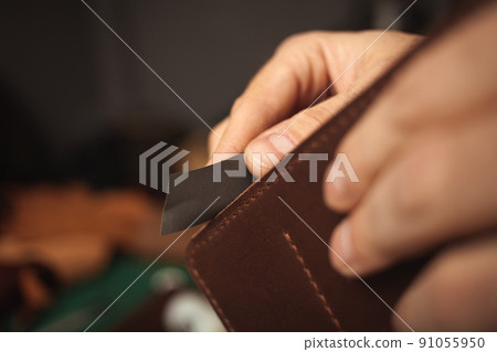 sandpaper. tanner makes leather wallet, professional craftsman, business Handiwork 91055950