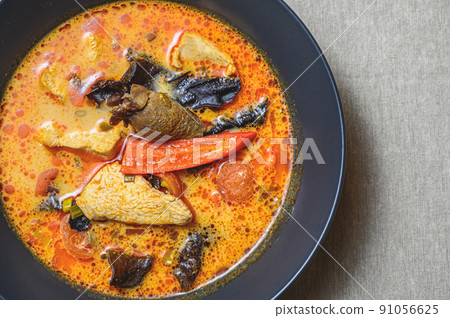 A bowl of delicious hot Tom Kha Gai soup. East Asian cuisine. A bowl of delicious hot Tom Kha Gai soup. East Asian cuisine. 91056625