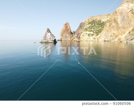 Abstract aerial sea summer ocean sunset nature background. Small waves on water surface in motion blur with golden bokeh lights from sun. Holiday, vacation and recreational concept. Slow motion 91060506