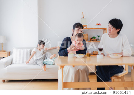 Family surrounding children and dining table 91061434