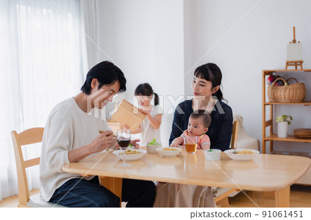 Family surrounding children and dining table Family surrounding children and dining table 91061451