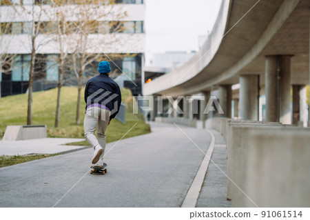 young man skater riding on skateboard. skateboarding city outdoor. Banner copy space young man skater riding on skateboard. skateboarding city outdoor. Banner copy space 91061514