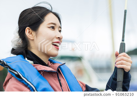 Cute woman fishing Cute woman fishing 91063210