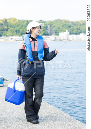 Cute woman enjoying fishing Cute woman enjoying fishing 91063891