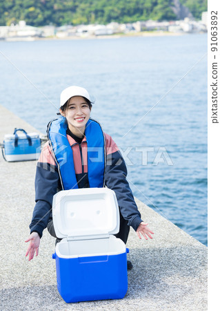 Cute woman enjoying fishing Cute woman enjoying fishing 91063892