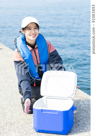 Cute woman enjoying fishing Cute woman enjoying fishing 91063893