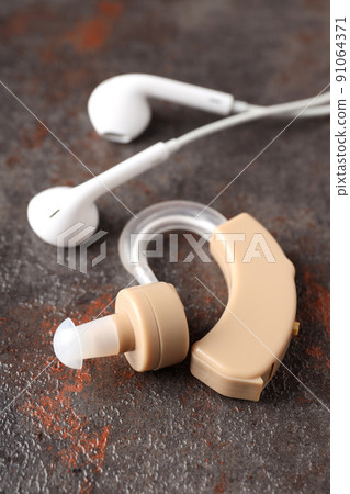 Concept of health care with hearing aid on dark textured background 91064371