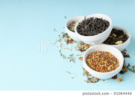 Concept of cooking tea with different types of tea on blue background 91064448