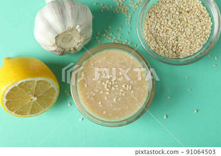 Concept of tasty food with tahini sauce on mint background 91064503