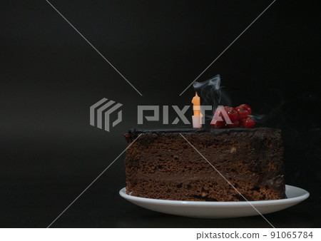 Piece of chocolate birthday cake with one extinguished candle on white plate on deep black background. Birthday party, celebration, anniversary. Close-up, copy space for your text. Piece of chocolate birthday cake with one extinguished candle on white plate on deep black background. Birthday party, celebration, anniversary. Close-up, copy space for your text. 91065784