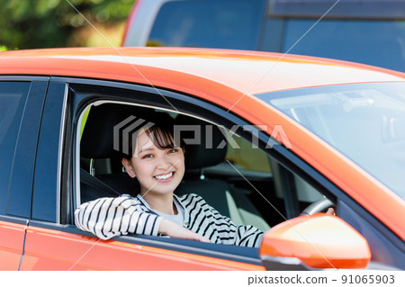 微笑著駕駛汽車的年輕女子 91065903