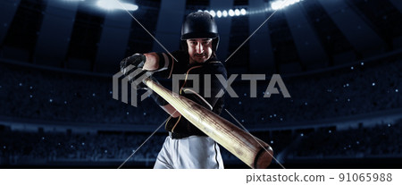 Front camera view of of professional baseball player with baseball bat in action during match in crowed sport stadium at evening time. Sport, win, winner, competition concepts. Front camera view of of professional baseball player with baseball bat in action during match in crowed sport stadium at evening time. Sport, win, winner, competition concepts. 91065988