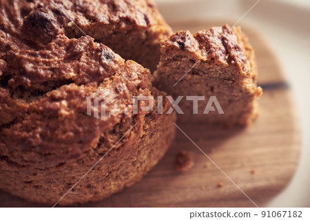 A close-up of a pie where a piece is cut off from the whole part. Diet dessert - Banana cake without milk, gluten-free, egg-free. High quality photo 91067182