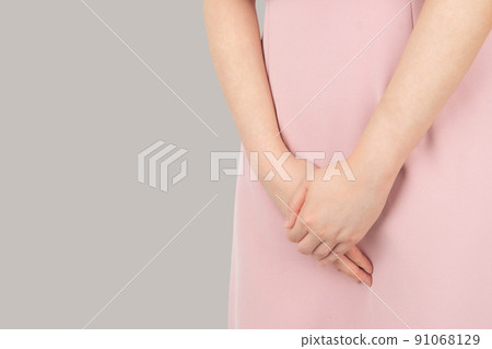 Woman hands holding her crotch suffering from pelvic pain or itchy. Gynecological problems include menstrual disorders, urinary incontinence, genital tract infections, STDs or ovarian cysts. 91068129