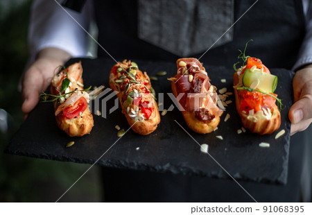 Eclairs with salmon, fresh vegetables and herbs, gourmet snacks. Eclairs with salmon, fresh vegetables and herbs, gourmet snacks. 91068395