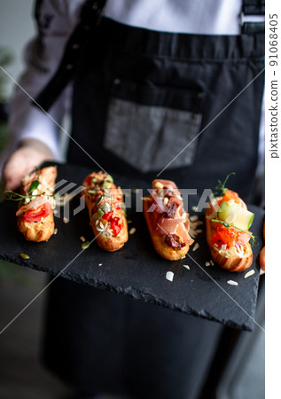 Eclairs with salmon, fresh vegetables and herbs, gourmet snacks. Eclairs with salmon, fresh vegetables and herbs, gourmet snacks. 91068405