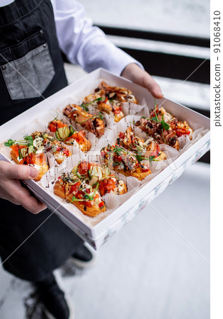 Eclairs with salmon, fresh vegetables and herbs, gourmet snacks. 91068410