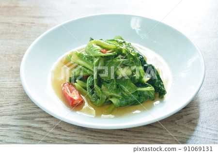 fried Brussels sprout with salty fish in oyster sauce on plate fried Brussels sprout with salty fish in oyster sauce on plate 91069131