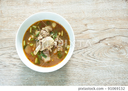 hot and spicy duck meat with tamarind and Thai herbs soup on bowl  91069132