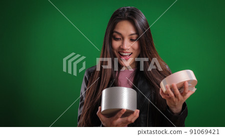 Attractive woman is very surprised and happy with her gift 91069421