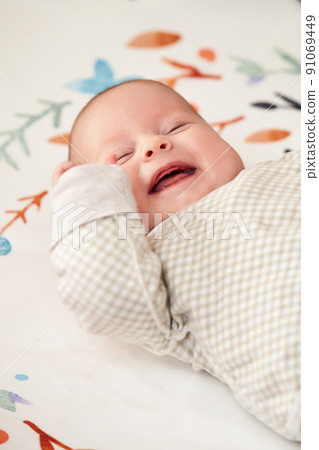 happy newborn baby in crib at home happy newborn baby in crib at home 91069449