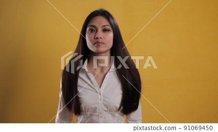 Self-confident satisfied young woman against neutral background Self-confident satisfied young woman against neutral background 91069450