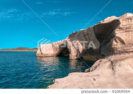 Unique rocks of Sarakiniko beach, Aegean sea, Milos island , Greece. No people, empty cliffs, summer sunshine, clear sea waters, cyan-pinkcolors 91069564