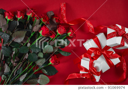 Top view fresh red rose flower and gift box on red deck with emp Top view fresh red rose flower and gift box on red deck with emp 91069974