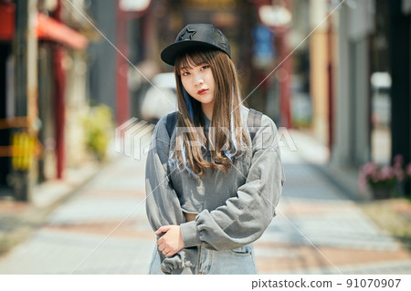 Gen Z women standing looking at the camera 91070907